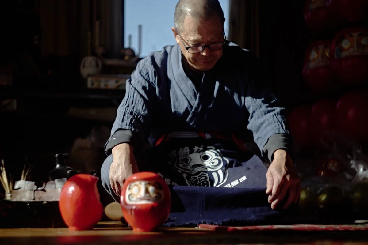 Artisan with daruma