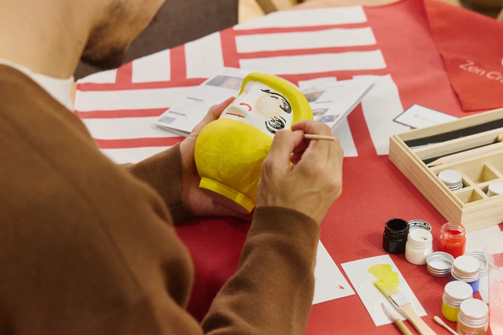 Hand-painted Daruma doll in traditional Japanese workshop